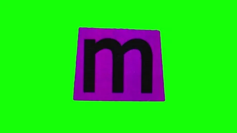 Small letter m on purple small crumpling and unwrapping sheet of paper in stop Stock Footage 251832334