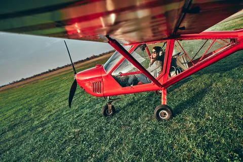 Small light airplane ready to flight on the airport field. Stock Photos