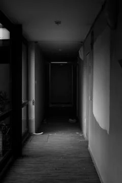 Small light at the end of an dark corridor Stock Photos