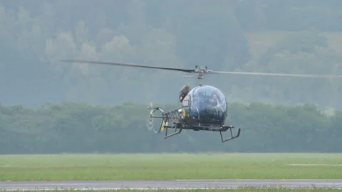 Small light retro helicopter landing with green nature background 動画素材 167021402
