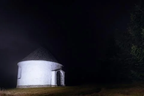Small lighten chapel in deep dark foggy evening in Czechia mountaines Stock Photos