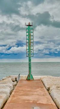 Small lighthouse in Caorle, in a cloudy day of September Stock Photos