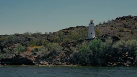 Small lighthouse on a cliff face above a desert river or lake in Arizona Stock Footage 241498117