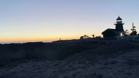 A small lighthouse lit up at sunset in San Francisco, California Stock Footage 254031401