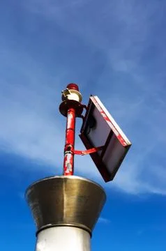 Small lighthouse with red bulb Stock Photos