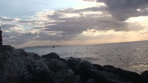 Small lighthouse in the sea with clouded sky Stock Footage 10760629