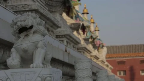 Small Lion statue flags waving in the background Stock Footage 72578136