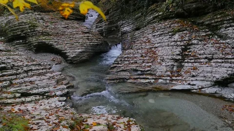 Small lively Psaho river streams through the autumn stone gorge in Caucasus 4K Stock Footage 84566064