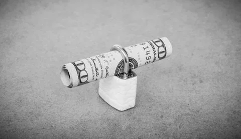 A small lock with dollar bill Stock Photos