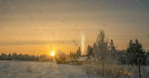 A small log cabin near the forest, a beautiful snowfall in the sunset, a Stock Footage 104463422