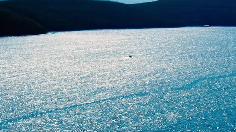 A small lonely boat sailing at open sea. Stock Footage 153807687