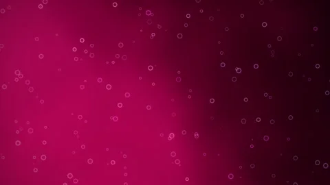 Small, luminous bubbles drift across a deep pink to dark purple gradient Stock Footage 346883935