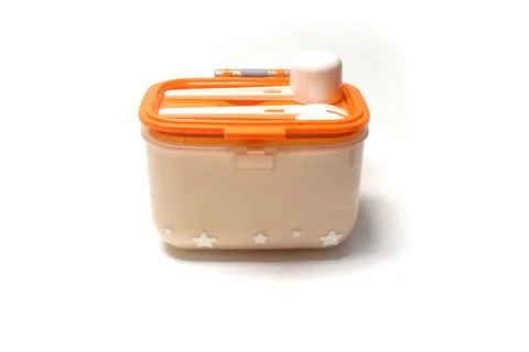 Small lunch box with plastic spoon and fork on top, isolated on white backg.. Stock Photos
