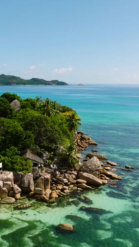Small lush island surrounded by turquoise waters. Praslin, Seychelles. Stock Footage 311786442