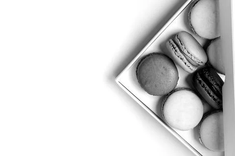 Small macarons in the box with copy space black and white style Stock Photos