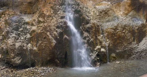 Small magical waterfall on a granite wall Stock Footage 85726368