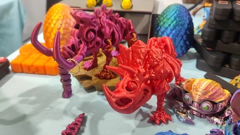 Small mammoth skeleton printed 3D printer from molten plastic of pink and orange Stock Footage 303955823