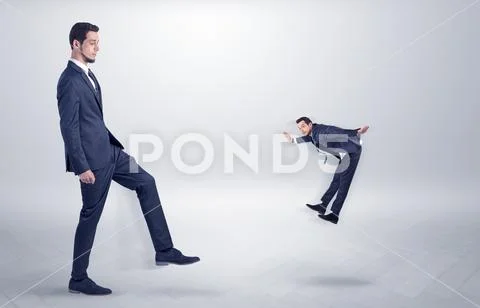 Small man fired by boss with white wallpaper Stock Photos