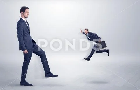 Small man fired by boss with white wallpaper Stock Photos