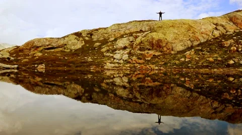 Small man standing on big mountain. epic landscape scenery. Stock Footage 42947944