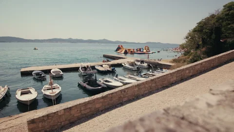 Small marina and inflatable water park in Zadar Vídeos de archivo 340073022
