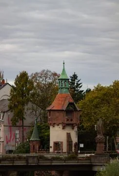 Small medieval tower on the bridge. Empty european street on the cloudy autumn d Stock Photos