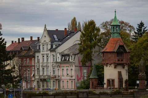 Small medieval tower on the bridge. Empty european street on the cloudy autumn d Stock Photos