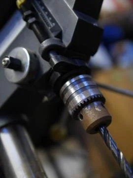 Small Metal Drill Press at an Angle with Bit Stock Photos