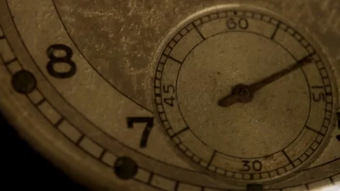 Small metal hand ticks clockwise on a vintage dial 動画素材 329598020