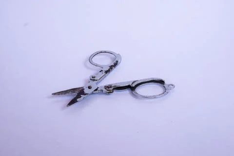 Small metal scissors with white isolated object. Stock Photos