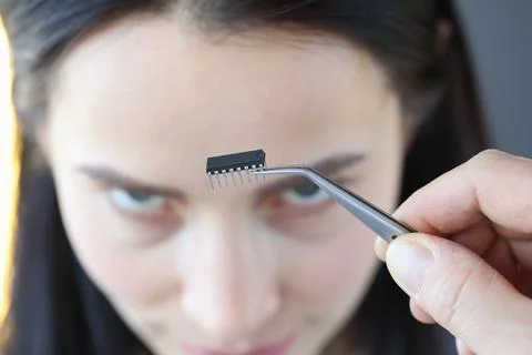 Small microcircuit chip in front of woman's head 写真素材