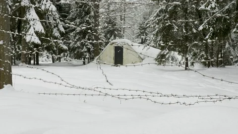 Small military old bunker surrounded by barbed wire in winter forest Stock-Footage 101588487
