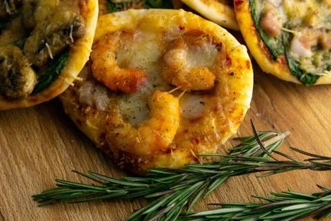Small mini pizza. Set of different mini pizzas. Pizza: with shrimp, with mush Stock Photos