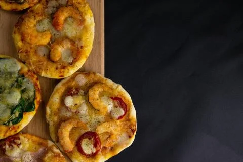 Small mini pizza. Set of different mini pizzas. Pizza on wooden board: with s Stock Photos