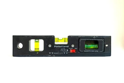 Small, mini, pocket sized construction spirit level. Isolated white background. 写真素材