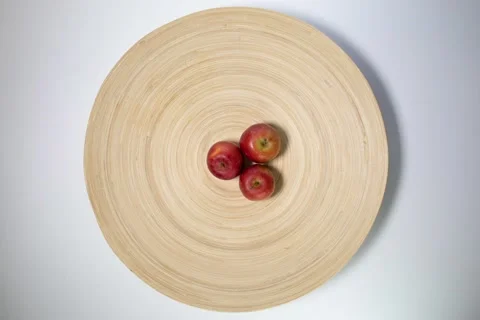 Small mini red cherry lady apple on wooden plate white  background stop motion  Stock Footage 132379165