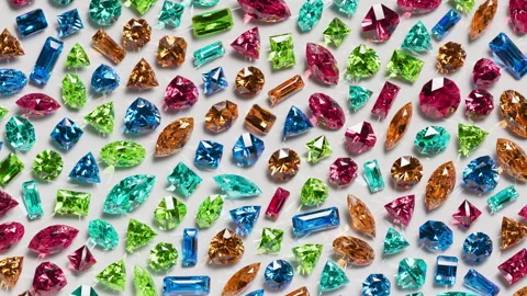 Small mixed gems rolling diagonally in a colorful loop. Stock Footage 329164804