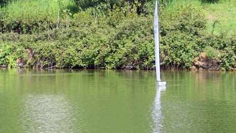 Small model of sailboat in the pond - 4K - ProRes Stock Footage 153278580