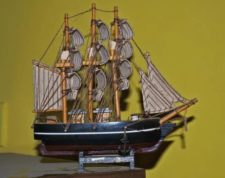 Small model of sailing ship on dirty table... Stock Photos