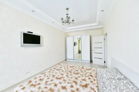 A small modest bedroom without a decor with a beautiful ceiling Foto stock