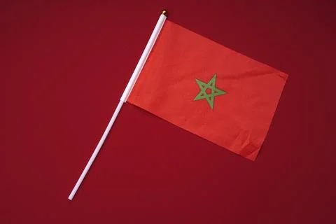Small Moroccan flag isolated on a red background. Stock Photos