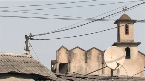 Small mosq in Douala zoom from parabolic antenna to street Stock Footage 80459961