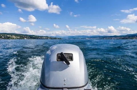 Small motor boat engine close up at full speed on lake Zurich sunny day Stock Photos