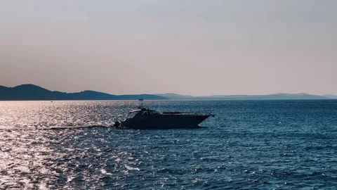 A small motor boat sails quickly through the sea, the silhouette Stock Footage 260147307