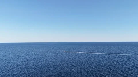 Small Motorboat Leaving Long Wake Across Open Sea Stock Footage 340509322