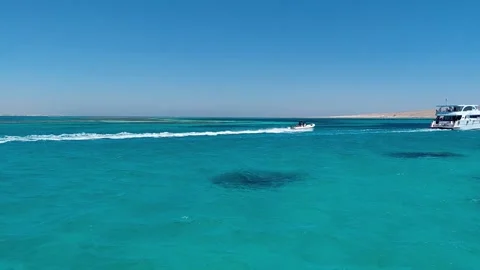 Small motorboat trailing white wake near yacht in turquoise sea Hurghada 스톡 동영상 341326280