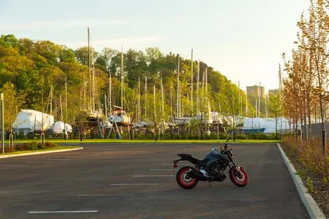 Small motorcycle in empty parking next to the Sillery marina at dawn Foto stock