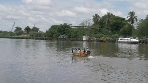 Small motorized boat passing through old port of Banjarmasin Stock Footage 142123012