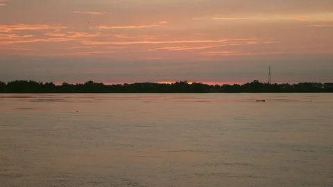 Small motorized boat proceeding on river at sunrise Stock Footage 80920107