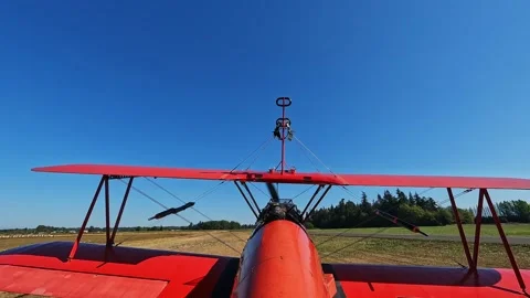 A small motorized plane is driving on an unpaved runway Stock Footage 274723497